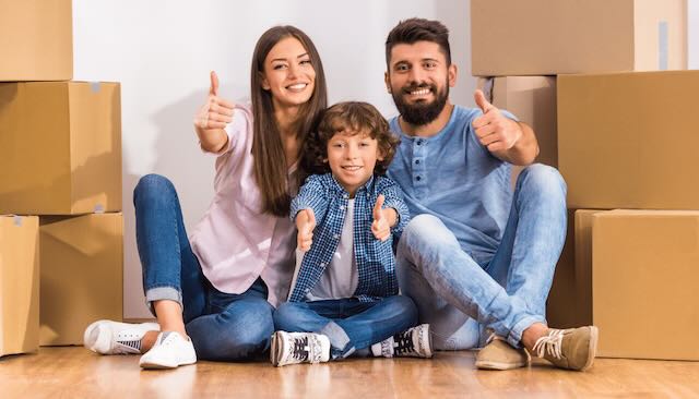 Family surrounded by moving boxes